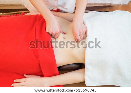 Masseur conducts anti-cellulite massage of the abdomen