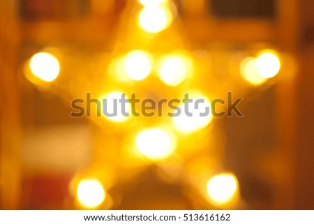 Christmas and New Year's star is shining brightly. Festive colored lights and gold. Background for a card. Background for a card. Blurred images and beautiful bokeh.