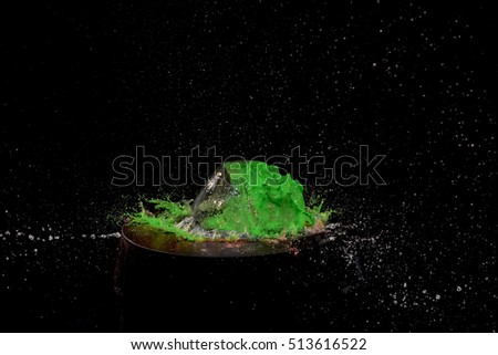 water splash with green color on black background