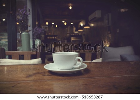 Coffee cup in coffee on table in cafe