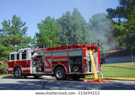 fire truck in residential area with woods on fire Royalty-Free Stock Photo #513694213