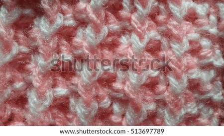 Close up of a pink knitted wool pattern, soft focus