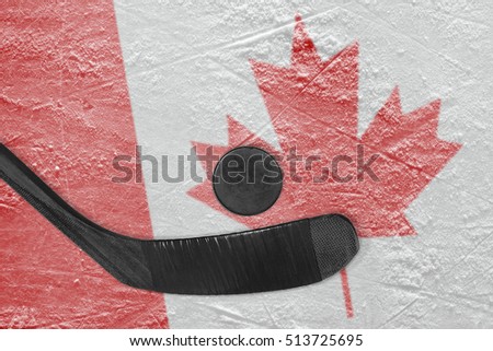 Hockey puck, stick, and the image of the Canadian flag on the ice. Concept, hockey