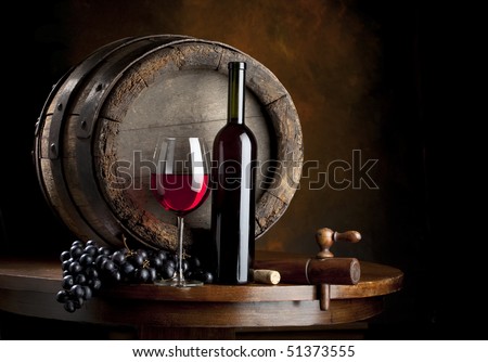 the still life with red wine, bottle, glass and old barrel Royalty-Free Stock Photo #51373555