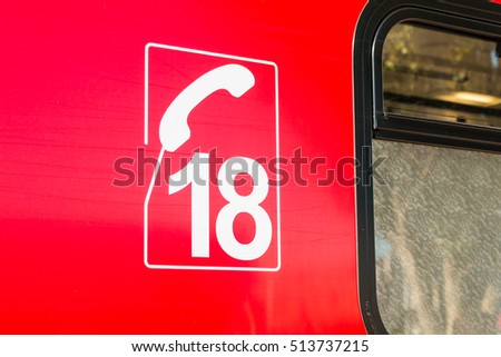 closeup on the number of the french phone of firefighters on ambulance truck. 18