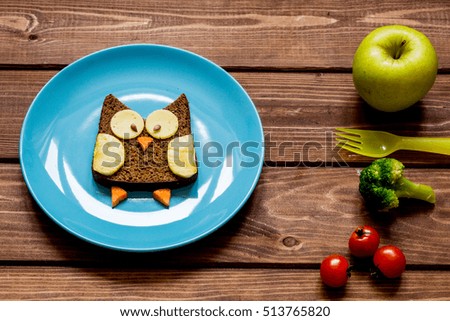 breakfast for child on blue plate at wooden background