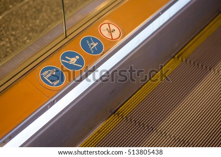 signs on an escalator, warning signs, the escalator at the mall