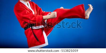 In a suit of Santa Claus the sportswoman is beating kicking