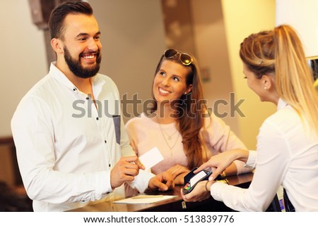 Picture of couple at counter paying for hotel