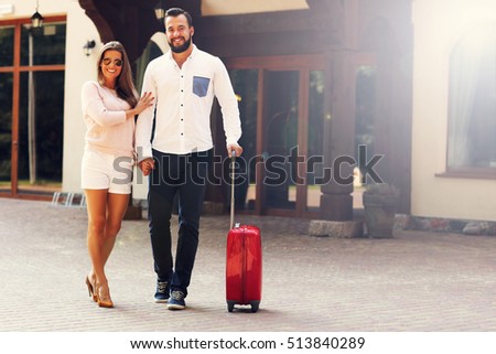 Picture of young couple walking out of hotel