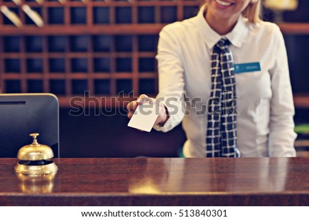 Picture of receptionist giving key card Royalty-Free Stock Photo #513840301