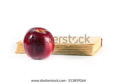 fine ripe red apple and old book