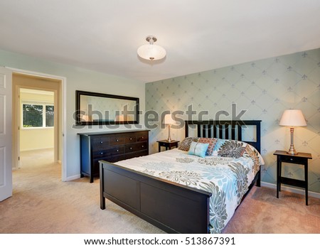 Traditionally furnished bedroom with black furniture and carpet floor. Northwest, USA
