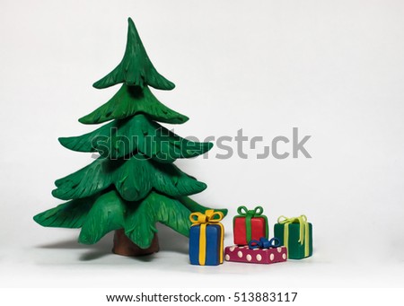 
Christmas tree and colorful gifts on a white background. Cobbled together by hand from clay Royalty-Free Stock Photo #513883117