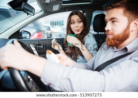 Side view of beauty couple in car. man at the wheel