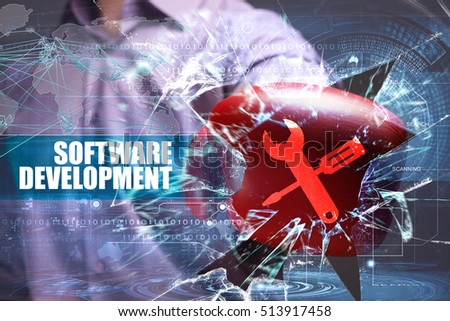 Business, Technology, Internet and network concept. Young businessman breaks the virtual future of the screen on which the inscription: software development
