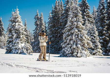 Skier woman looking in smart phone