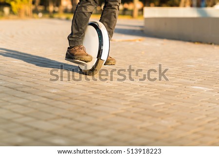 Man legs mono wheel personal electrical transport street outdoor Royalty-Free Stock Photo #513918223