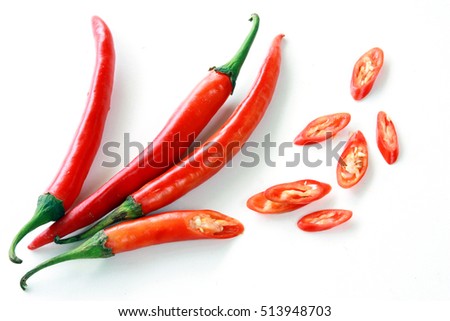 Fresh red chilli delicious savory slices on a white background. Royalty-Free Stock Photo #513948703