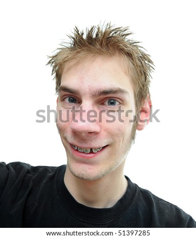An average looking young adult smiles at the camera with slightly crooked teeth isolated on white background.