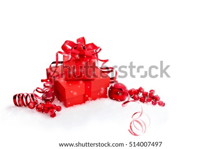 Christmas decoration with red gift boxes, christmas berries, serpentine and christmas toy on white background with space for text.