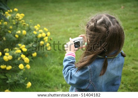 an image of a little girl holding camera