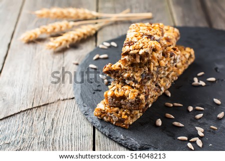 Roasted nuts and sunflower seeds in caramel and sugar on the old wooden background. Selective focus. Royalty-Free Stock Photo #514048213