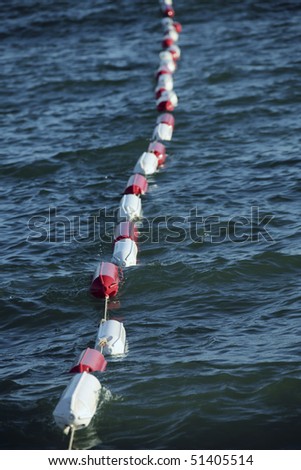 an image of several buoys on the water