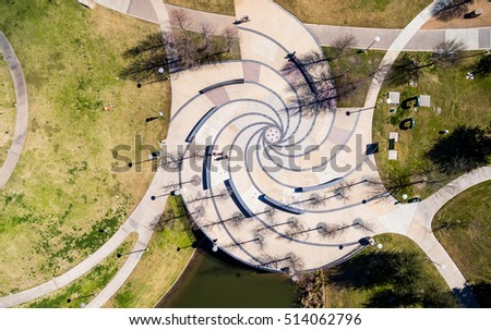 Looking straight down above modern spiral galaxy style architecture fountain outdoor park near downtown Austin Texas