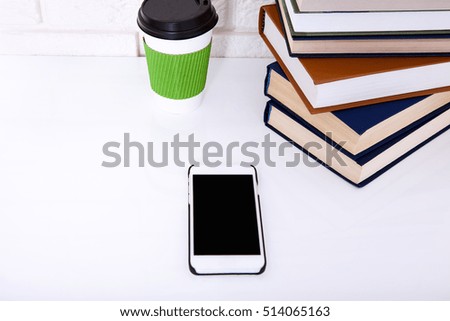 Business workplace with accessories on white table near brick wall with copy space. Selective focus