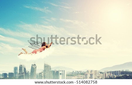 Young pretty woman flying in sky and playing fife