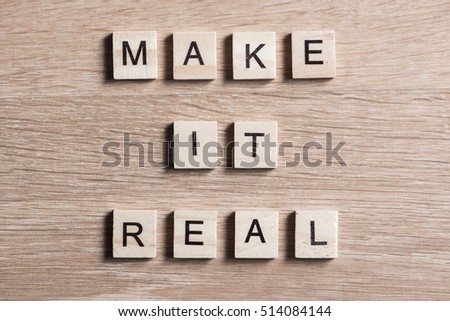 Make it real phrase collected of wooden elements with the letters