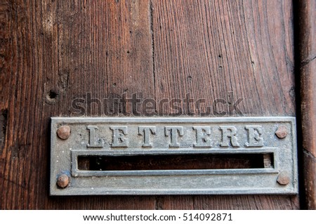 Retro letterbox on old wooden door