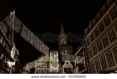 Strasbourg (France) Christmas illumination garlands and cathedral at background. Sepia.