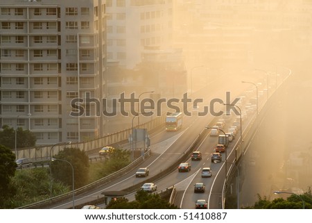 Air pollution scenic with cars on highway and yellow smoke in city. Royalty-Free Stock Photo #51410887