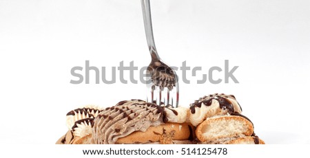 picture of a cake pieces of chocolate and vanilla filling.
