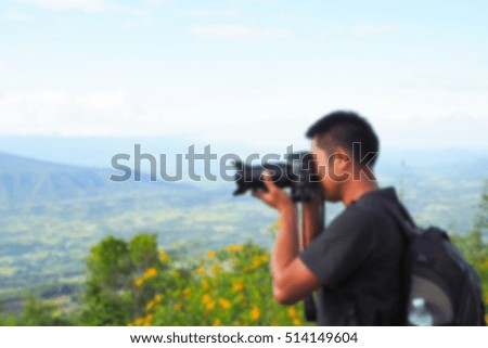 Man of photographers holding camera. blurred blur