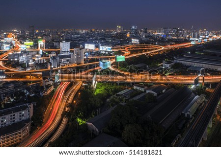 Highlight shadow of express way at twilight time in Bangkok, Thailand (With long exposure photography created movement of car light and blur trademark, brand, logo)