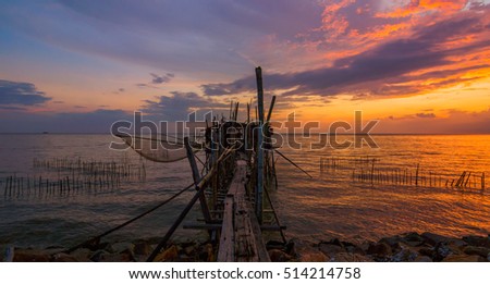 Sunset at beach with Jetty at Parit Jabar, Batu Pahat  Johor Malaysia. This image may contain noise,blurry clouds due to long exposure, soft focus and poor lighting
