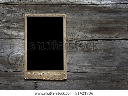 Antique photo frame on wooden background