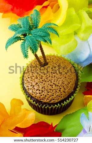 Cupcake background image with palm tree decorations pinned into the center of the desert