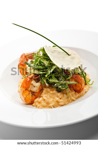 Risotto with Tiger Prawns and Rucola. Served with Parmesan Chip
