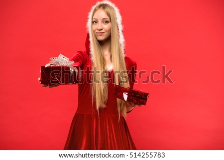 girl on a red background holds gift box