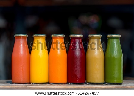 Raw vegetable and fruit juices in glass bottles Royalty-Free Stock Photo #514267459