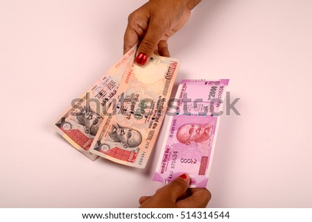 New Indian Currency publish on 2016, holding currency notes in women hand, exchange the old currency by new currency notes. New currency 2000 rupee note Royalty-Free Stock Photo #514314544