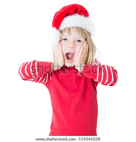 portrait of happy smiling blond girl in preschool age wearing santa claus costume, dressed as christmas elf, child looking satisfied and wicked, isolated on white background