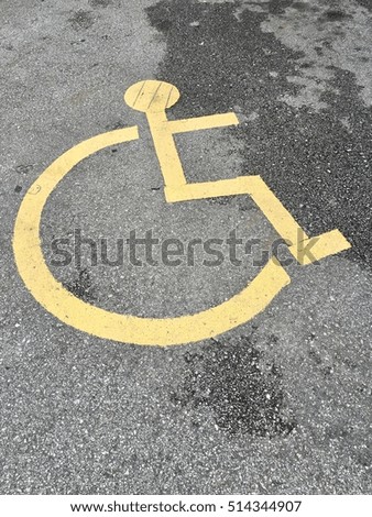 Handicapped parking symbol - transportation infrastructure road markings.