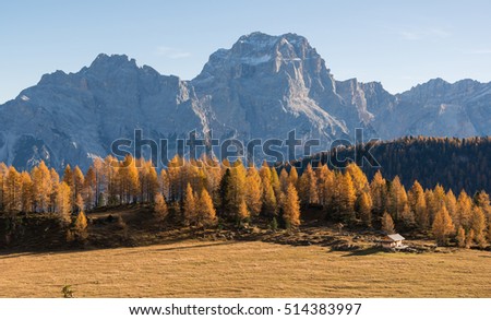 Autumn in Dolomites mountains above lake Federa.