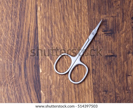 Scissors on wooden background. Copy space