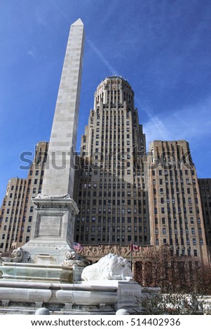 Daytime picture of Buffalo City Hall with McKinley Monument in the foreground and blue sky in the background.